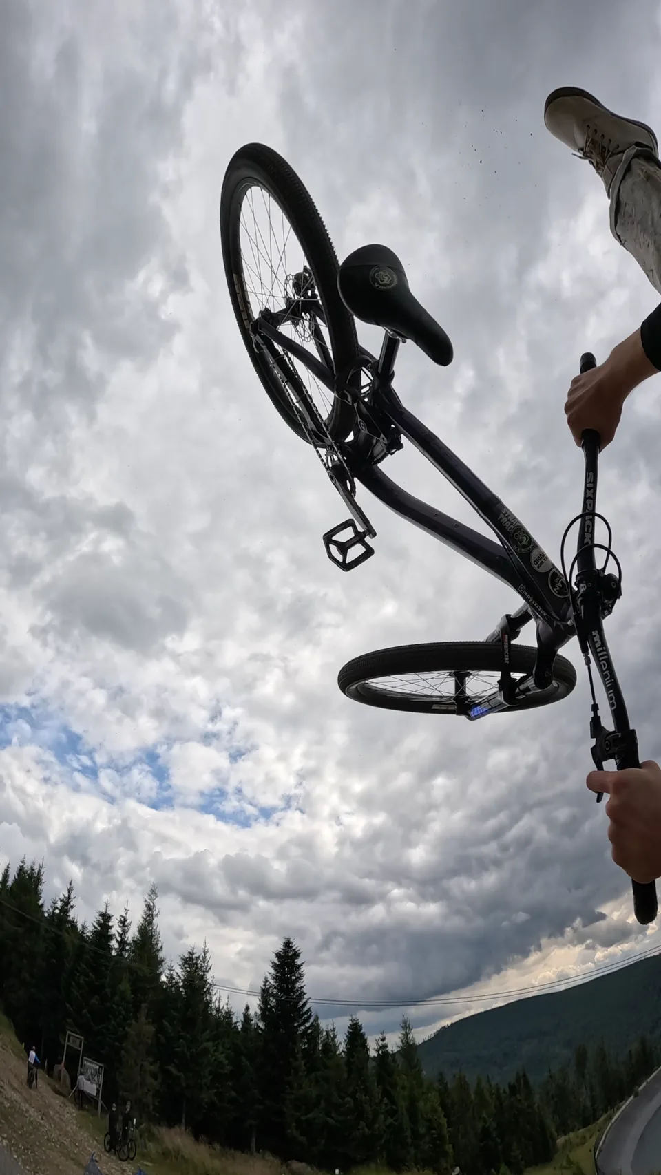 Mateusz Mamcarz controls his bike in the air during training